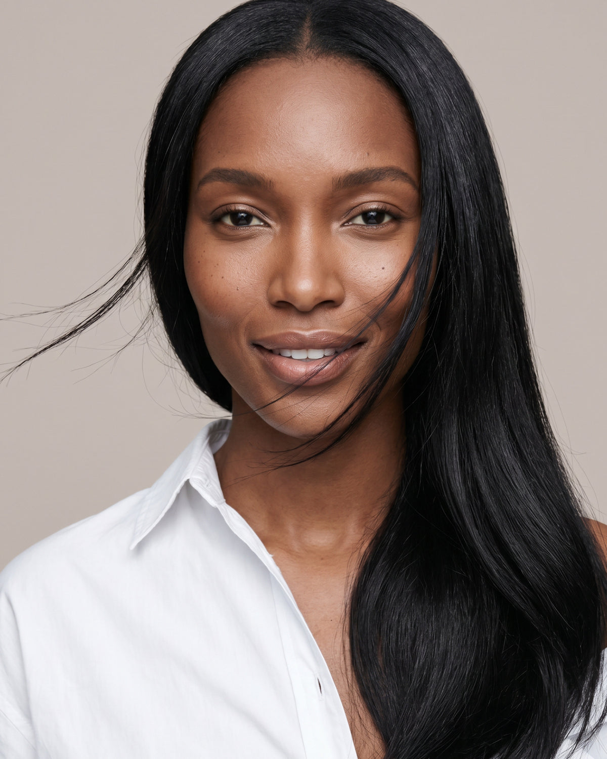 Woman with long, smooth and shiny hair after using GRANTED T.01 leave-in hair treatment