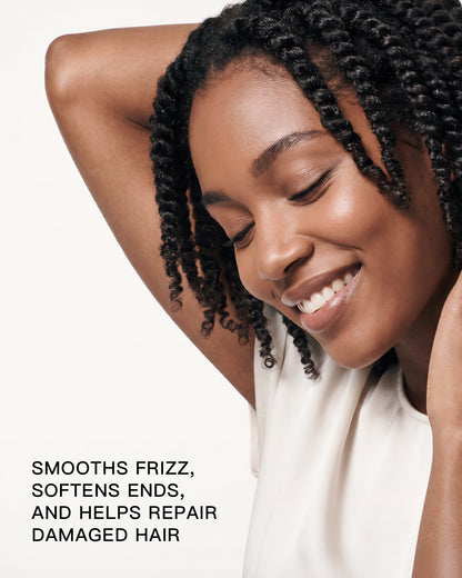 Woman with textured hair highlighting GRANTED T.01 leave-in treatment for frizz and damaged hair